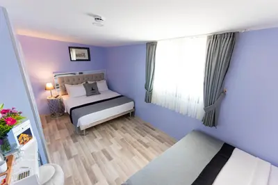 a blue bedroom with a bed and a window at Primero Hotel in Istanbul