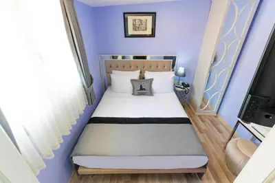 a bedroom with a bed with blue walls at Primero Hotel in Istanbul