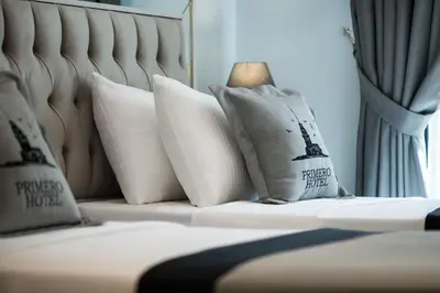 a bed with white pillows on top of it at Primero Hotel in Istanbul