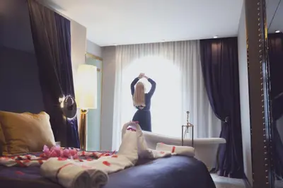 a bedroom with a bed and a window and a room with at Sura Design Hotel & Suites in Istanbul