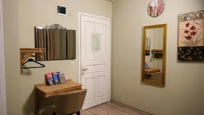 a room with a door and a mirror and a chair at Second Home Suites in Istanbul