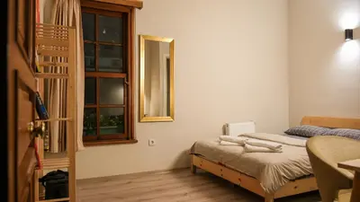 a small bedroom with a bed and a window at Second Home Suites in Istanbul