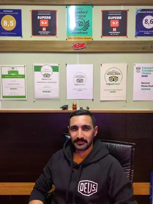 a man sitting in a chair in front of a desk at Second Home Suites in Istanbul