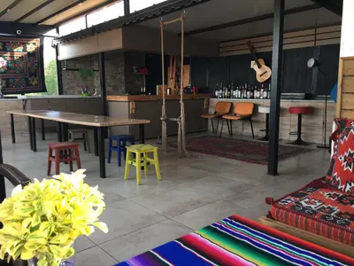 a room with a table and chairs and a bar at Second Home Suites in Istanbul