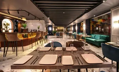 a restaurant with a table and chairs and a bar at Concept Nisantasi Hotels & Spa in Istanbul