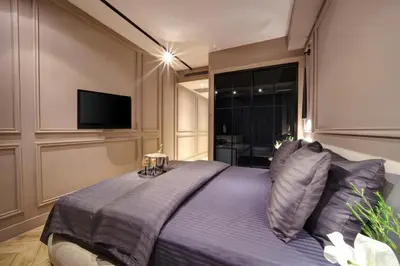 a bedroom with a large bed with a flat screen tv at Concept Nisantasi Hotels & Spa in Istanbul