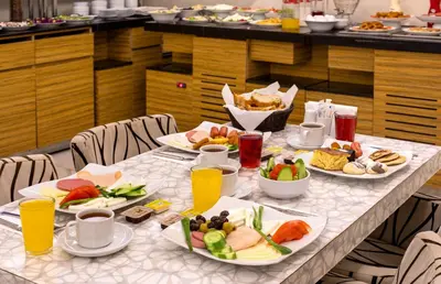 a long table with plates of food on it at Deluxe Newport Hotel - Old City in Istanbul