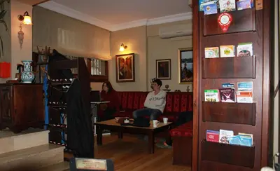 two people sitting on a couch in a living room at Hotel SultanHill in Istanbul