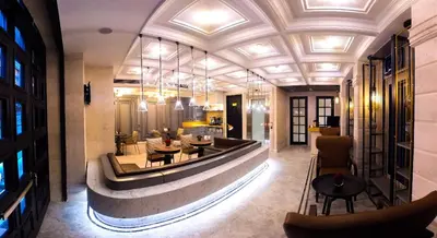 a lobby of a hotel with tables and chairs at Maroon Tomtom in Istanbul
