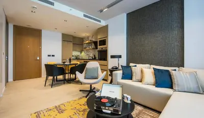a living room with a couch and a table at WestSide Residences by Rotana in Istanbul
