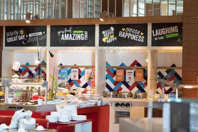 a kitchen with signs on the wall of a restaurant at Hampton By Hilton Bursa in Bursa