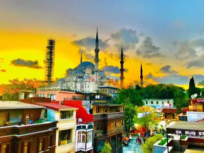 a view of a city with a mosque at sunset at Charm Hotel in Istanbul