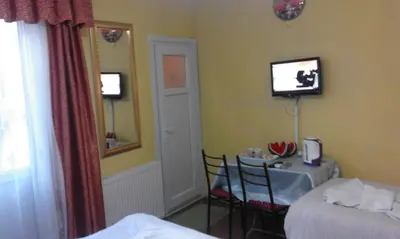 a hotel room with a table and a tv on the wall at Bereket traveler Hotel in Istanbul