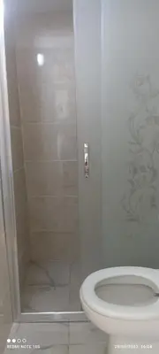 a bathroom with a white toilet and a shower at Bereket traveler Hotel in Istanbul