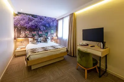 a bedroom with a bed and a desk with a computer at Riva's Moda in Istanbul