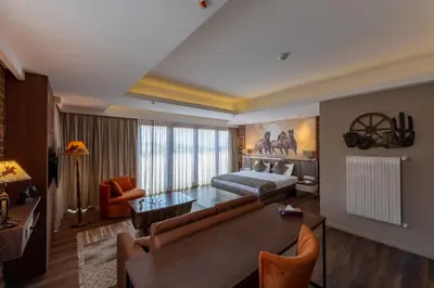 a living room with a couch and a bed and a table at Riva's Moda in Istanbul