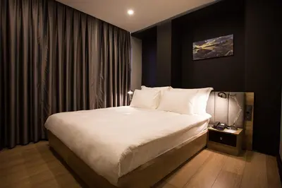 a bedroom with a large bed with white sheets at Long Stay İstanbul Residence in Istanbul