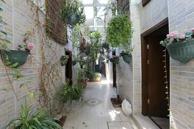 an empty hallway with potted plants in a building at Yeşilköy Airport Hotel in Istanbul