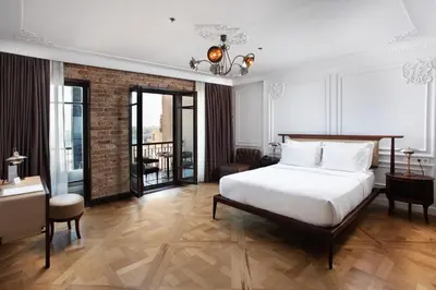 a bedroom with a large white bed and a balcony at Georges Hotel Galata in Istanbul