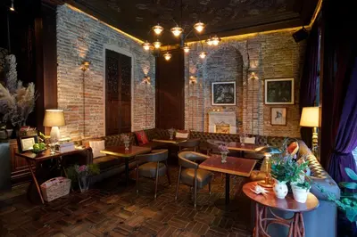 a restaurant with tables and chairs and a brick wall at Georges Hotel Galata in Istanbul