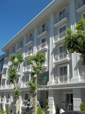 a large white building with trees in front of it at Innova Sultanahmet Istanbul in Istanbul