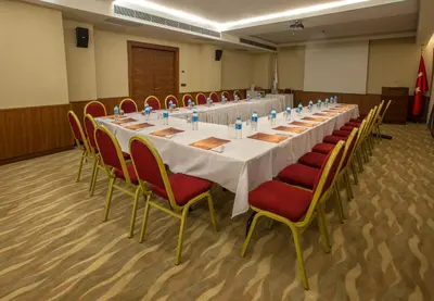 a long table in a room with red chairs at Innova Sultanahmet Istanbul in Istanbul
