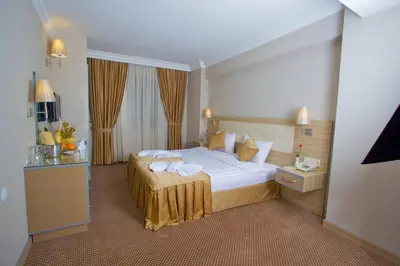 a hotel room with a bed with towels on it at Laleli Emin Old City Hotel in Istanbul