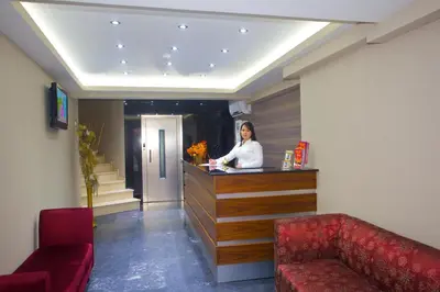 a woman standing at a counter in a hotel room at Laleli Emin Old City Hotel in Istanbul