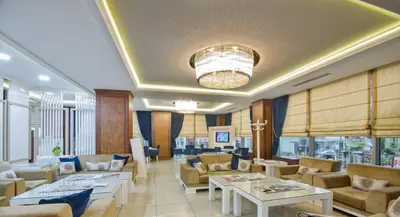 a living room with couches and tables and windows at Grand Eyuboglu Hotel in Istanbul