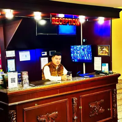 a man sitting at a bar looking at his cell phone at Grand Anatolia Hotel in Istanbul