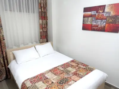 a bedroom with a bed and a painting on the wall at Istanberry - Paradise Apartments in Istanbul