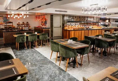 a restaurant with tables and chairs and a counter at Vespia Hotel in Istanbul