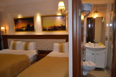 a hotel room with two beds and a sink at Blue Istanbul Hotel in Istanbul