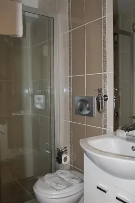 a bathroom with a shower and a toilet and a sink at Blue Istanbul Hotel in Istanbul