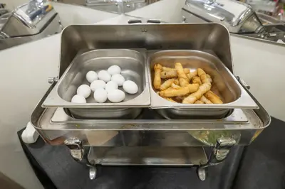 two trays of eggs and french fries in a toaster at Tugra Hotel in Istanbul