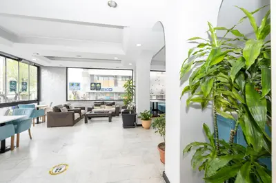a lobby of a restaurant with plants at Tugra Hotel in Istanbul