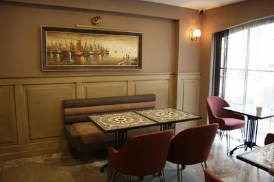 a living room with a couch and a table and chairs at Endless Comfort Hotel Taksim in Istanbul