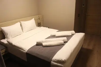 a white bed with two towels on top of it at Endless Comfort Hotel Taksim in Istanbul