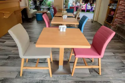 a row of tables in a restaurant with colorful chairs at Tayahatun Hotel in Istanbul