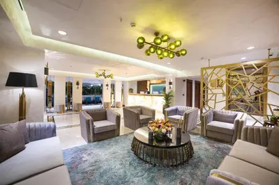 a living room with couches and a chandelier at Vogue Hotel Supreme Istanbul in Istanbul