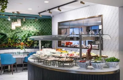 a buffet line with food on display in a restaurant at Vogue Hotel Supreme Istanbul in Istanbul