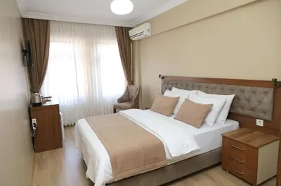 a bedroom with a large bed and a window at Ramparts Hotel in Istanbul