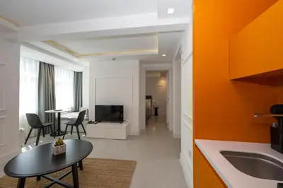 a kitchen and living room with a table and a television at Juno Hotel Taksim in Istanbul