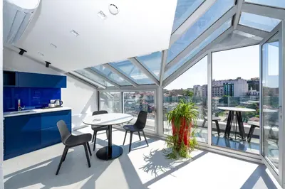 a kitchen with a table and chairs and glass windows at Juno Hotel Taksim in Istanbul