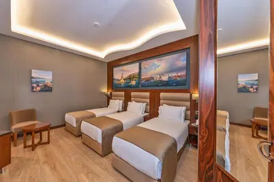 a hotel room with three beds in it at Piya Sport Hotel in Istanbul