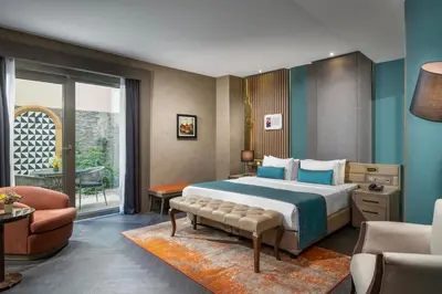a hotel room with a large bed and a chair at Aspera Hotel Altunizade in Istanbul