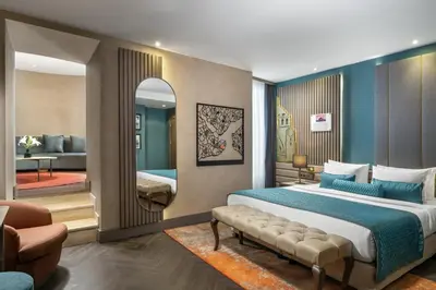 a bedroom with a large bed and a living room at Aspera Hotel Altunizade in Istanbul