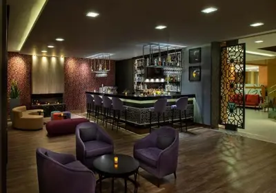a lobby with a bar with purple chairs and a counter at Dosso Dossi Hotels & SPA Golden Horn in Istanbul