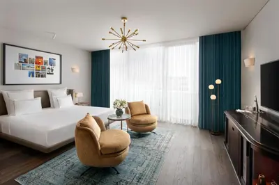 a hotel room with a bed and two chairs at Glens Palas Istanbul Nisantasi in Istanbul