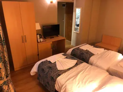 a hotel room with two beds and a television at Artika Hotel in Istanbul